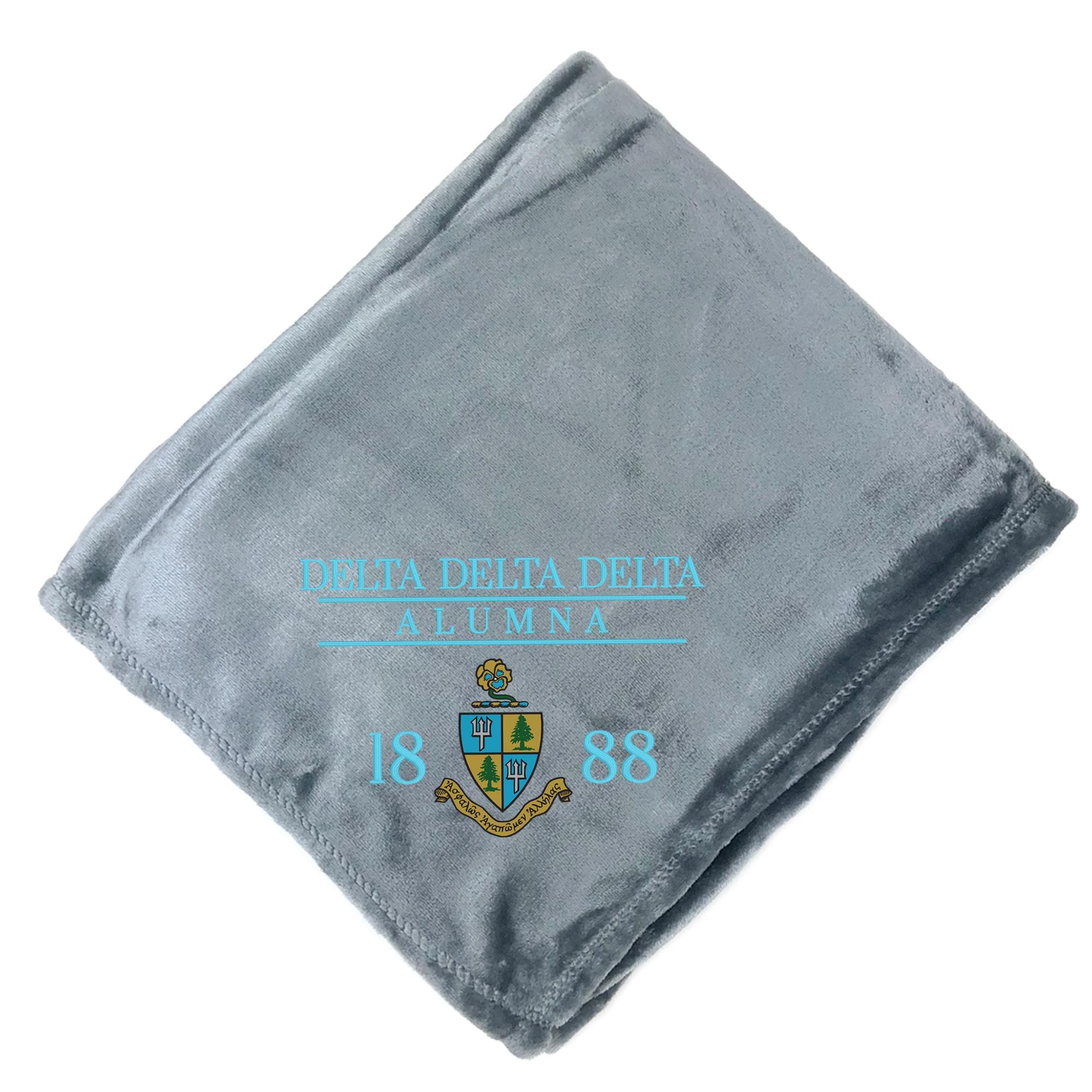 A gray fleece blanket with the text "Delta Delta Delta Alumna" and the year "1888" printed on it.