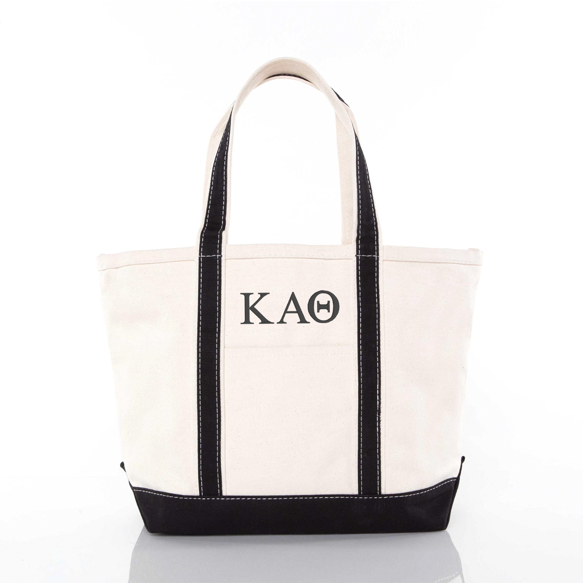 A white tote bag with black trim and the letters "KAO" printed on it.