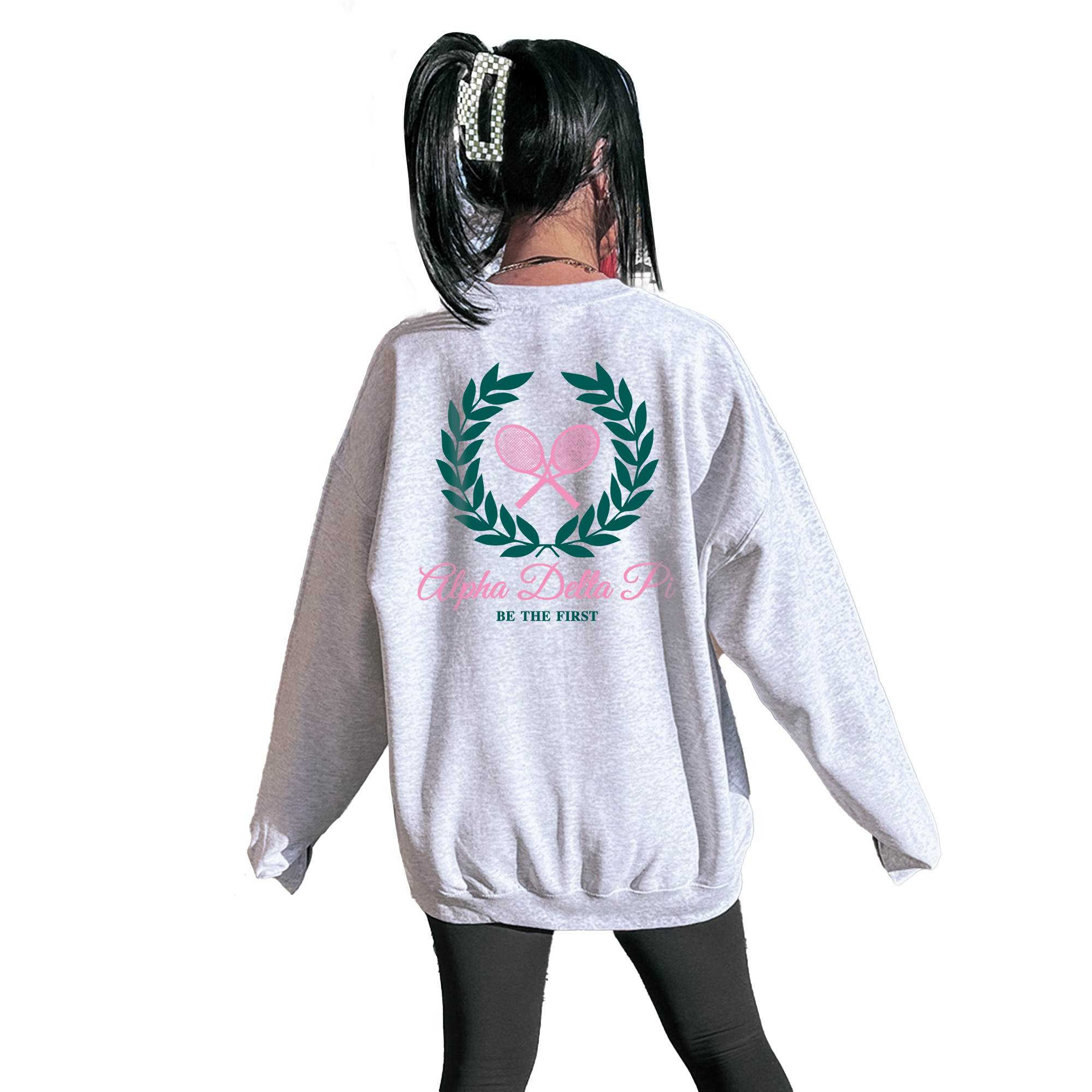 A person wearing a grey sweatshirt with a graphic design on the back.