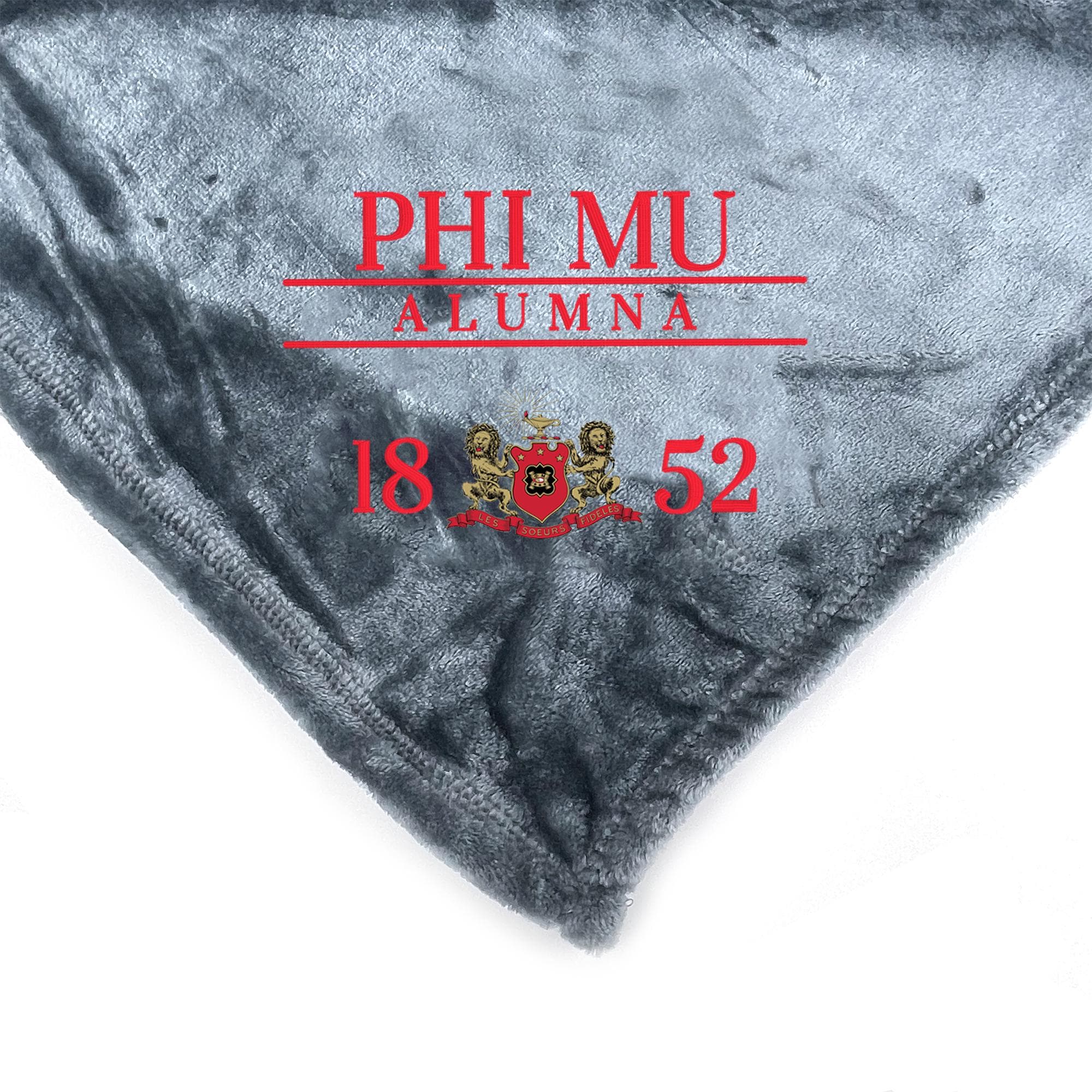 a gray fabric with red text and a coat of arms, along with the text "PHI MU ALUMNA 18 52".