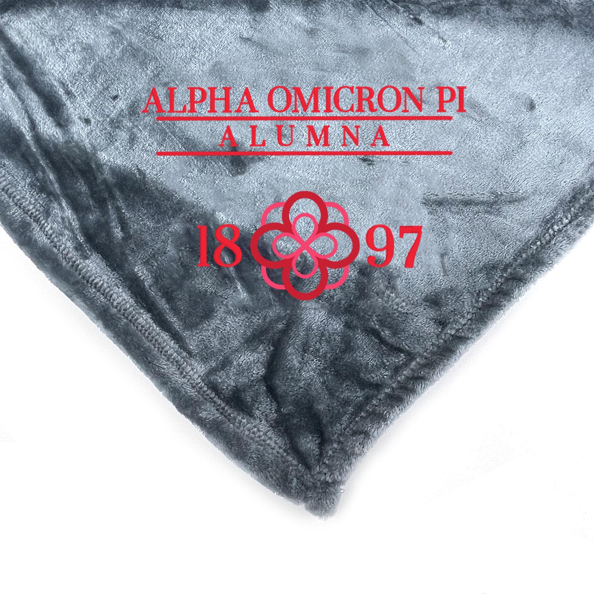 a gray fabric with red text and a red flower design.