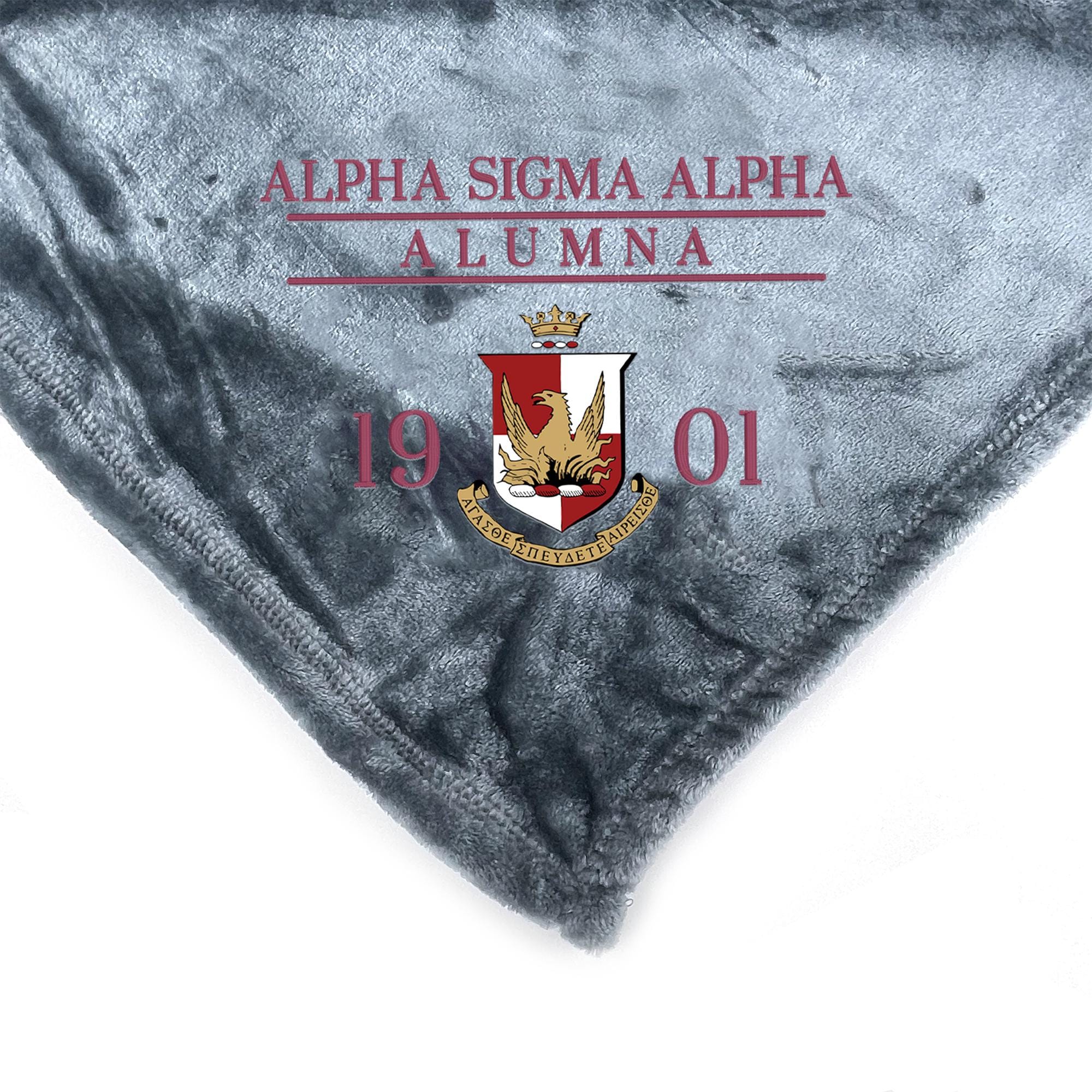 a gray blanket with the text "ALPHA SIGMA ALPHA ALUMNA 19 01" printed on it.