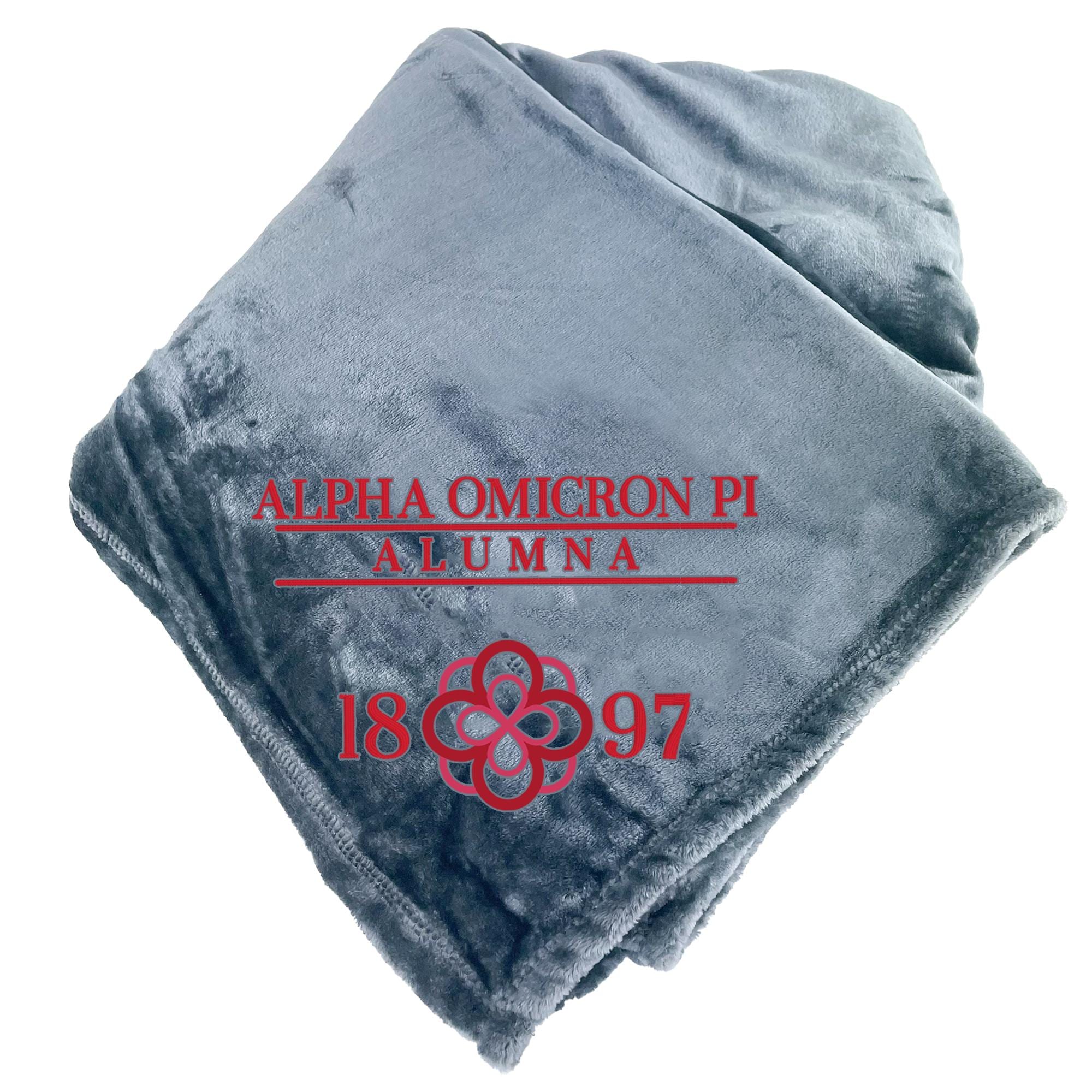a gray blanket with red text and a red flower design.