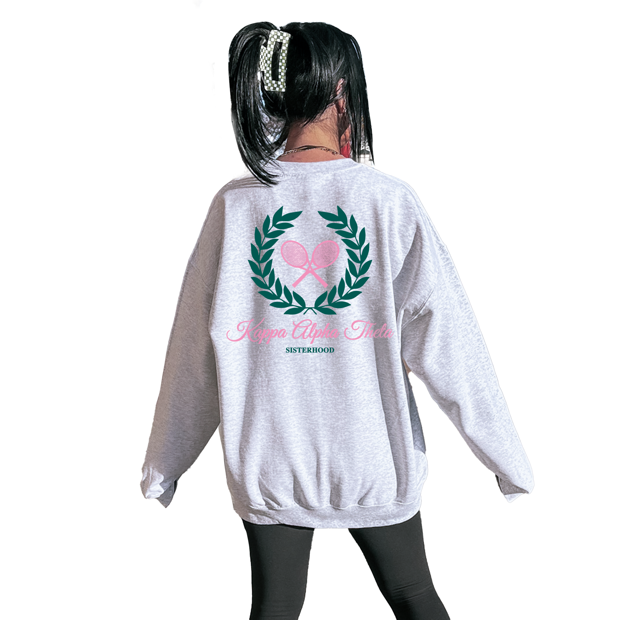 A person wearing a grey sweatshirt with a graphic design on the back.