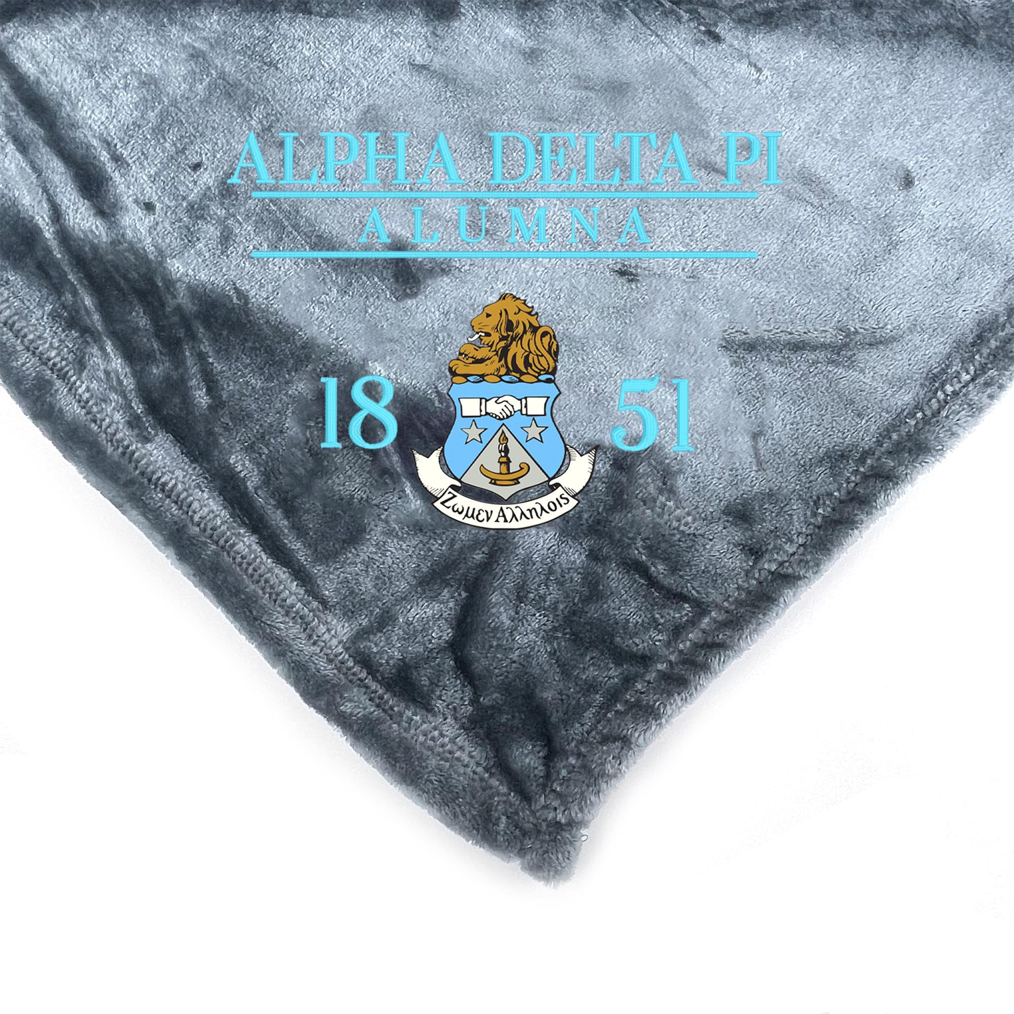 a close-up view of a gray fabric with a crest and text on it.