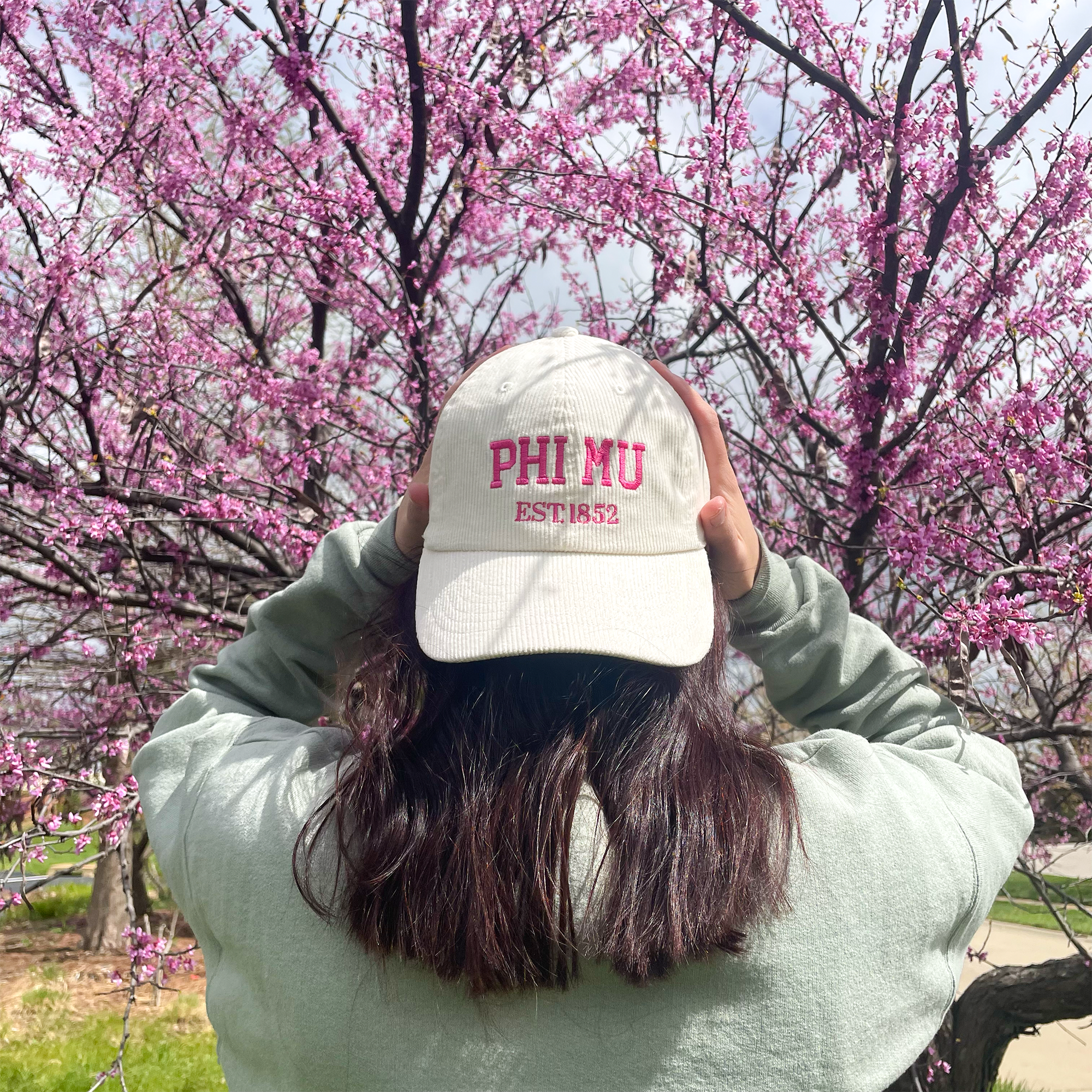 a person wearing a hat with the word phi phi on it
