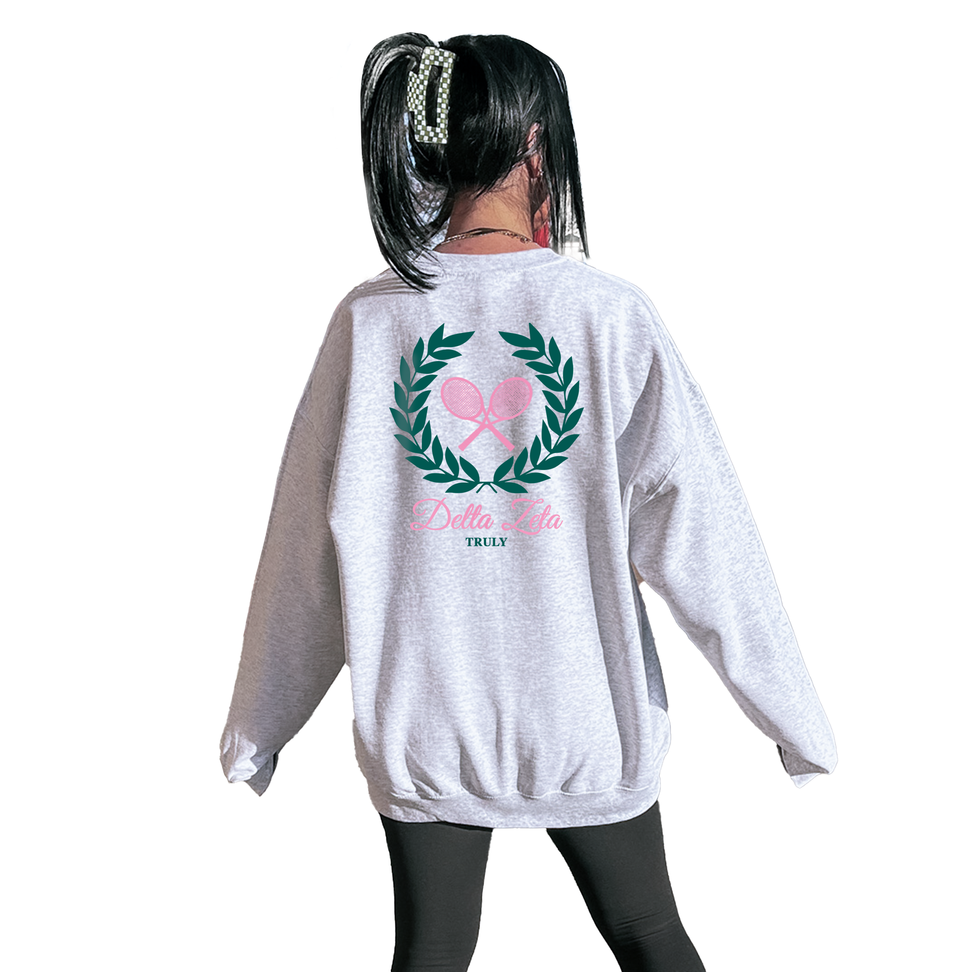 A person wearing a grey sweatshirt with a graphic design on the back.